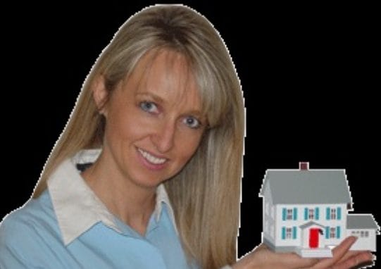 a woman is holding a model house in her hand